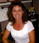 Kim Mason wearing a white shirt in a gray cubicle at V.R. Williams and Company in Winchester, TN