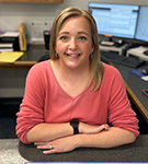 Alejandra Medley, commercial lines coverage specialist and pilot car account manager, wearing a red shirt at V.R. Williams and Company in Winchester, TN